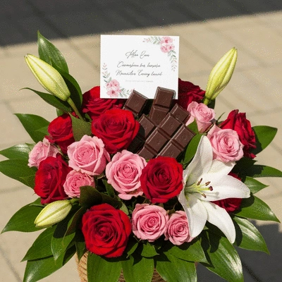 A beautifully arranged gift basket with flowers, chocolates, and a personalized card, soft focus background, product photography